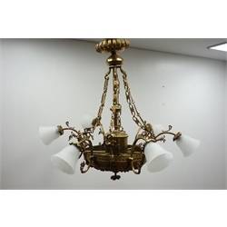  Large Regency style gilt metal electrolier, six scroll branches, foliate cast dome base, six conforming suspension chains and glass shades, H88cm   