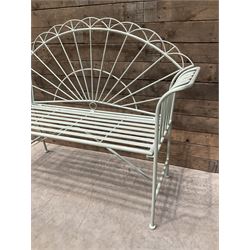 Wrought metal two seat garden bench, sunburst back, painted in pale green finish