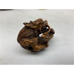 Hardwood bust of an Indoniesian Goddess, carved wearing a pierced headdress, from Klungkung, Bali, H20cm, together with a pair of bone carvings of deity figures, and a carved wood Netsuke in the form of a Chinese dragon