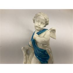 Victorian wall pocket by Moore Brothers retailed by T.Goode modelled as a semi nude white glaze cherub with turquoise ribbon, with encrusted floral decoration, the reverse stamped ‘T.Goode & Co.’, H32cm