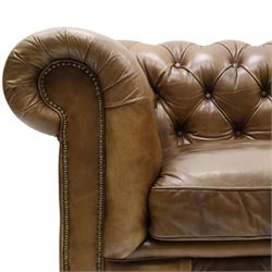 Timothy Oulton for HALO - Two seater brown leather chesterfield sofa, with button back and arms, with two loose cushions, raised on a dark stained supports terminating in castors 