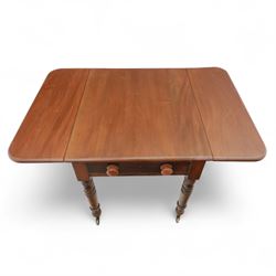 Mahogany drop-leaf Pembroke table circa 1900, with rounded rectangular top and single frieze drawer, raised on turned and tapered supports with brass castors (Extended 128cm)