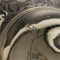 Early 20th century silver twin handled tazza, the bowl of circular form with pierced foliate decoration and ribbon and reed border, with two whiplash curved handles, upon a knopped stem and pieced foliate foot, hallmarked Walker & Hall, Sheffield 1911, H20cm