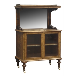  Victorian Burr walnut music cabinet, brass galleried top on scroll supports above a mirror, and two glazed doors enclosing two titled shelves all outlined with Tunbridge banding, on turned supports with brass beaded sockets and castors, W68cm, H106cm, D43cm  