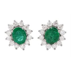 Pair of 18ct white gold emerald and diamond cluster stud earrings, stamped, total emerald weight approx 1.10 carat, total diamond weight approx 0.65 carat