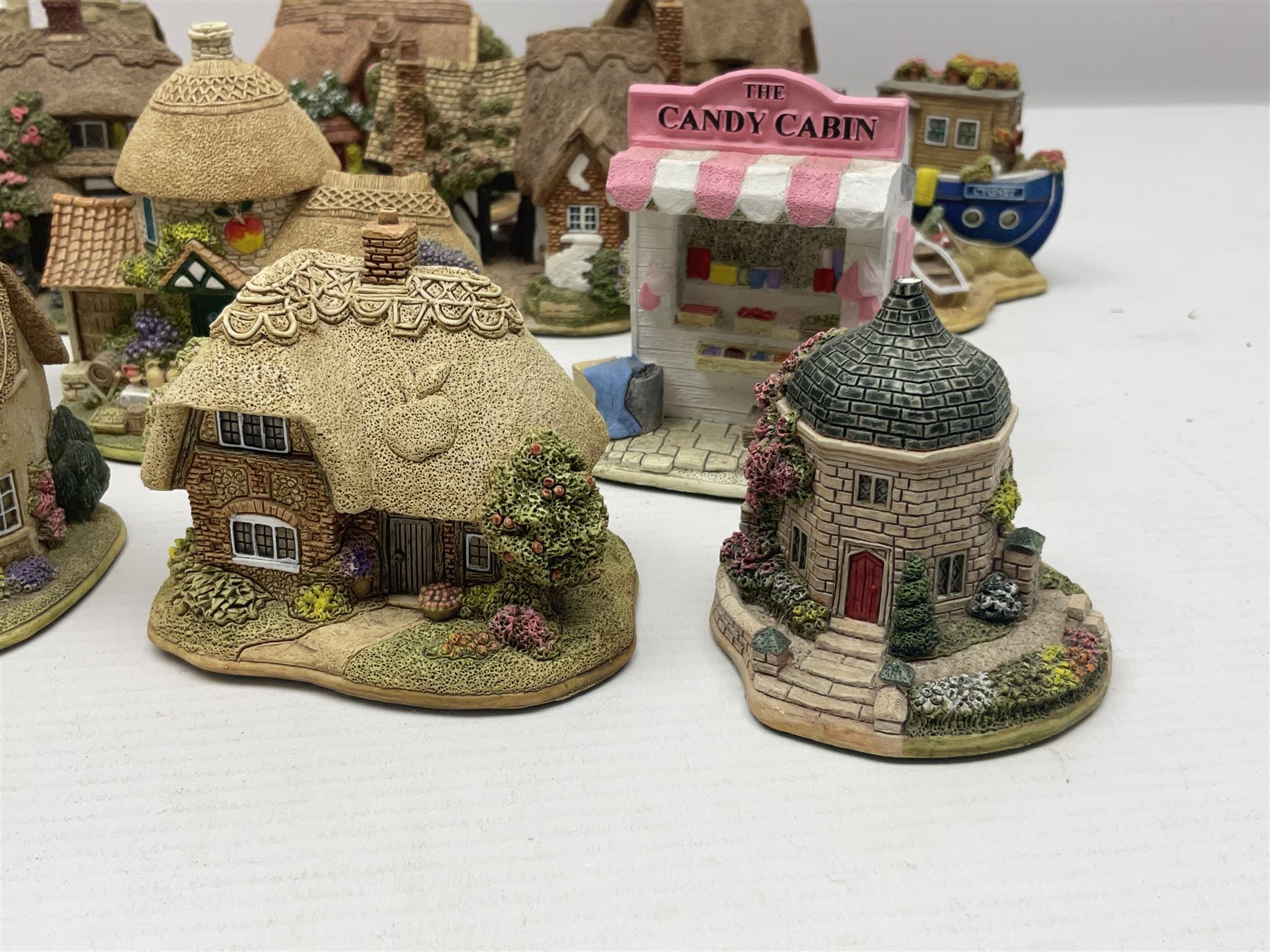 Eighteen Lilliput Lanes, including The Penny Farthing, The Pigsty, Borrowdale School, Fairy Cake Tearoom, An Apple a Day,Ladybird Cottage etc, all with original boxes 
