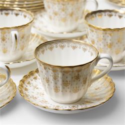 Spode Fleur de Lys tea and dinner service for ten, comprising dinner plates, side plates of graduating sizes, bowls, twin handled soup bowls, three covered dishes, sauce boat and saucer, two serving dishes, open serving dish, teapot, coffee pot, milk jug, covered sucrier, cake plate, vase, jardiniere, cups and saucers