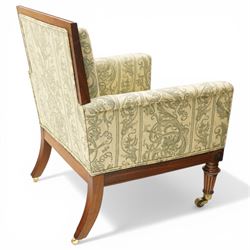 William IV rosewood framed library armchair, squared form with green on ivory ground upholstery, moulded lower seat rail with applied roundels over reeded supports, terminating to brass cups and castors