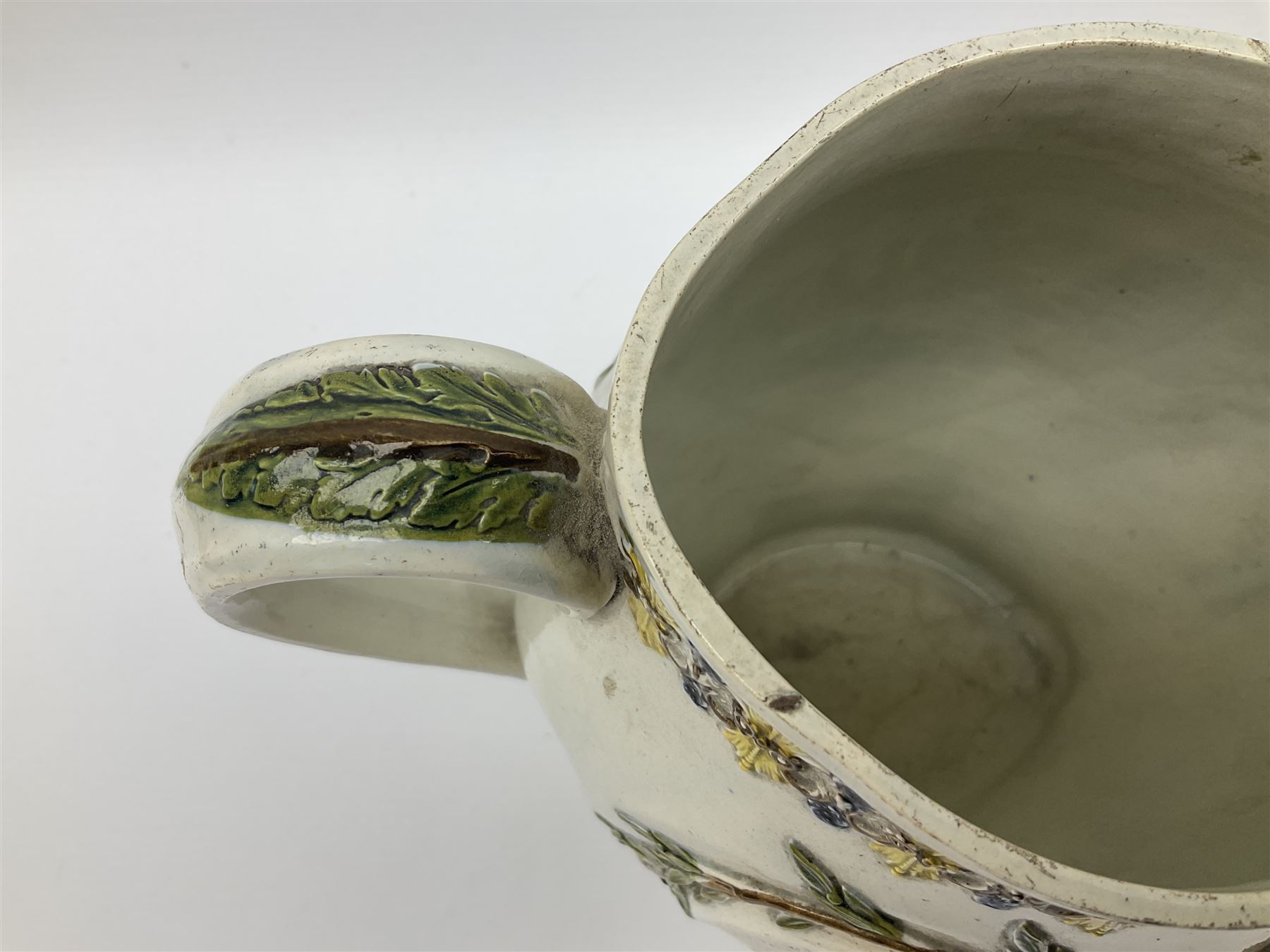 Early 19th century Prattware jug, circa 1800, decorated with two heart shaped panels of children, titled Sportive Innocence and Mischievous Sport, further decorated with acanthus and foliate borders, H22cm