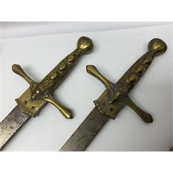 Near pair of short swords each with slightly curving 41cm fullered steel blade and all brass H-shaped hilt L52cm overall; plaited black leather whip; and reproduction pair of brass hilted swords, brass halberd blade and mace (7)