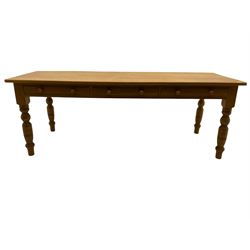 Farmhouse pine dining table, fitted with three drawers, turned legs