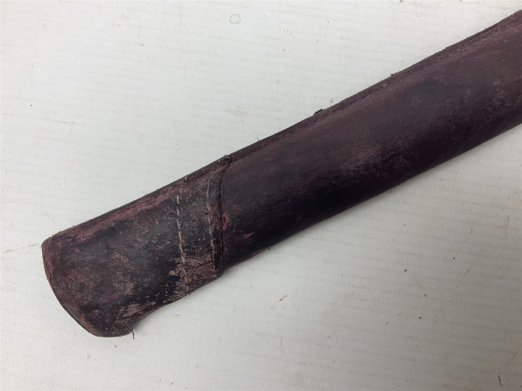 Copy of a WWII Japanese NCO sword, the 65cm slightly curving blade stamped with pseudo Japanese characters and cast brass simulated cord bound grip; in officer's leather bound field scabbard L97cm overall