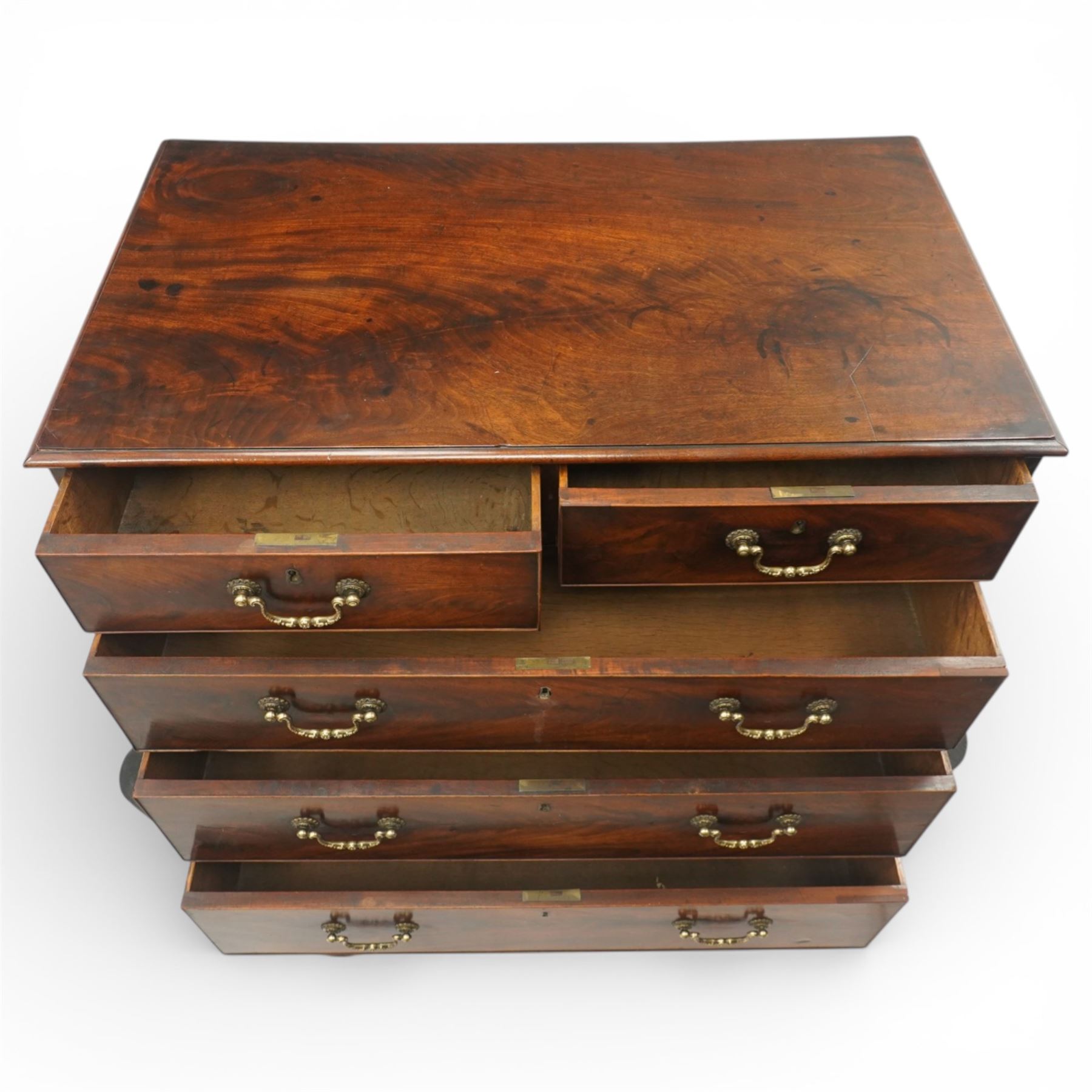 18th century Chippendale style mahogany chest of drawers, the moulded rectangular top above two short and three long drawers fitted with brass swan neck handles, raised upon original shaped bracket feet