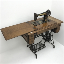 Singer oak and wrought metal framed treadle sewing machine, W94cm, H78cm, D46cm
