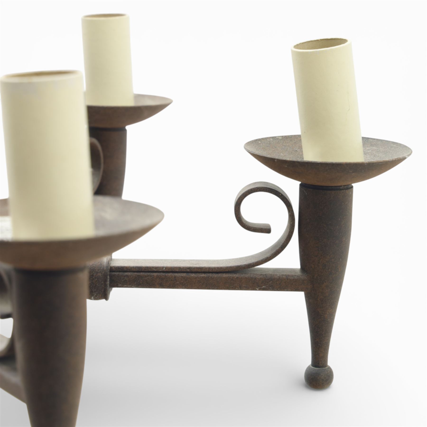 20th century wrought iron six branch chandelier, the central baluster stem issuing six scrolling arms supporting circular drip pan with drop terminals