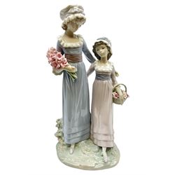 Lladro figure, Sisters, modelled as two sisters holding a basket of flowers and a floral bouquet, no 5013, year issued 1978, year retired 1991, H32cm  