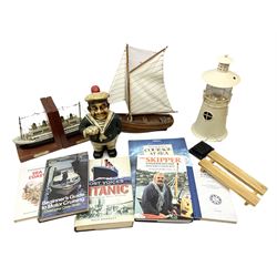 Nautical themed decorative items, to include Titanic book ends, model boat, books, lighthouse lamp etc in one box