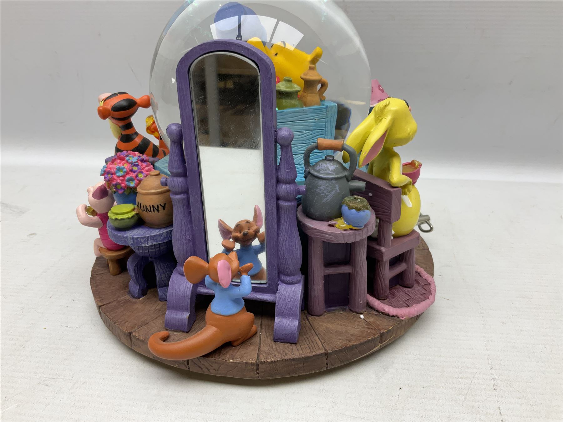 Five Disney Winnie The Pooh snow globes, to include Pooh and Piglet Sailing, Pooh's Grand Adventure and Blustery Day, together with The Walt Disney Classic Waterglobe collection globe and group Tigger, Winnie and Piglet figure under dome, all with boxes (7)