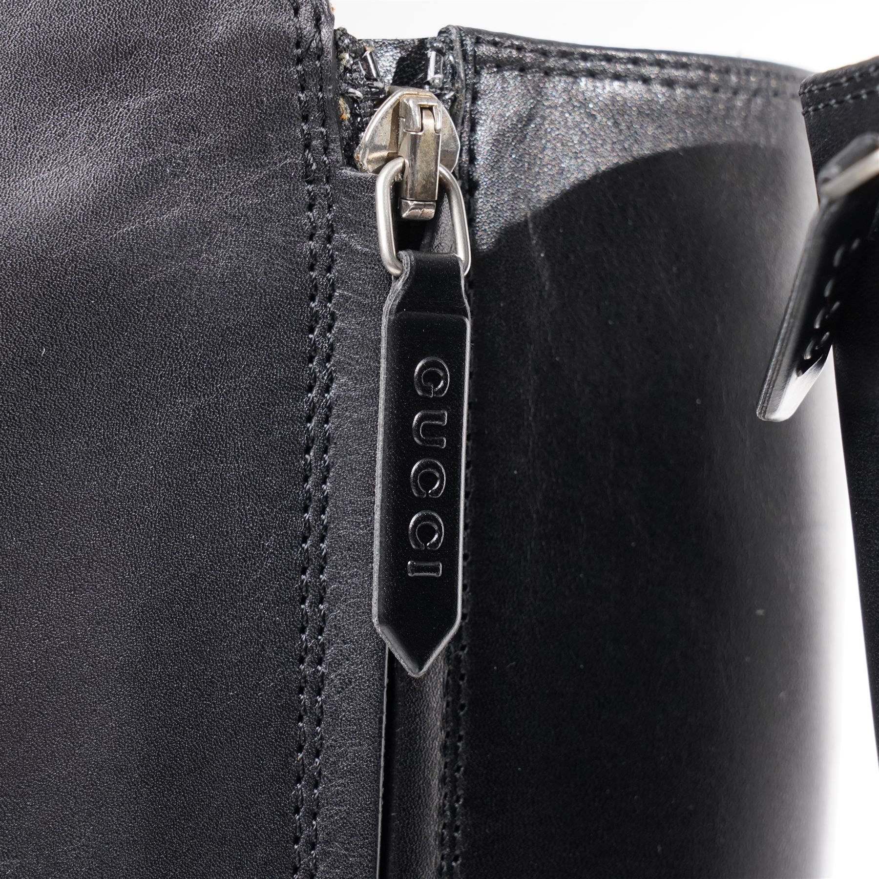 Gucci - pair of Dionysus buckled knee-high leather boots, in black with block heels, applied with rhinestone star, moon and heart applique motifs, with the signature silver tone tiger head buckle fastening and full length zip, size 38, total boot height 48cm, unused with original box and dust bags