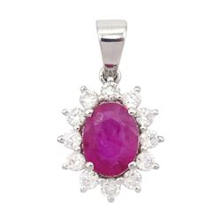 18ct white gold ruby and diamond pendant, single oval cut ruby of 1.15 carat surrounded by...