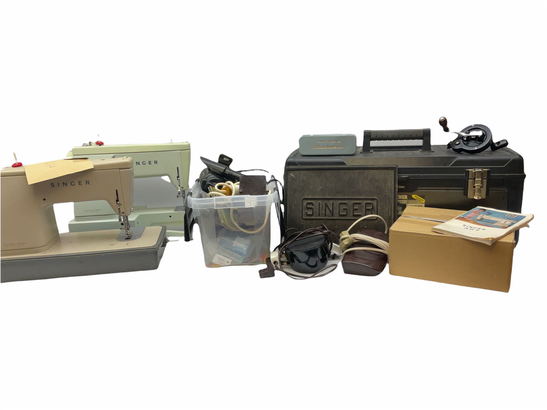 Two Singer sewing machines, model numbers 527 and 457, together with various Singer sewing machine parts, and a selection of sewing related accessories, to include threads, sewing needles, etc. 