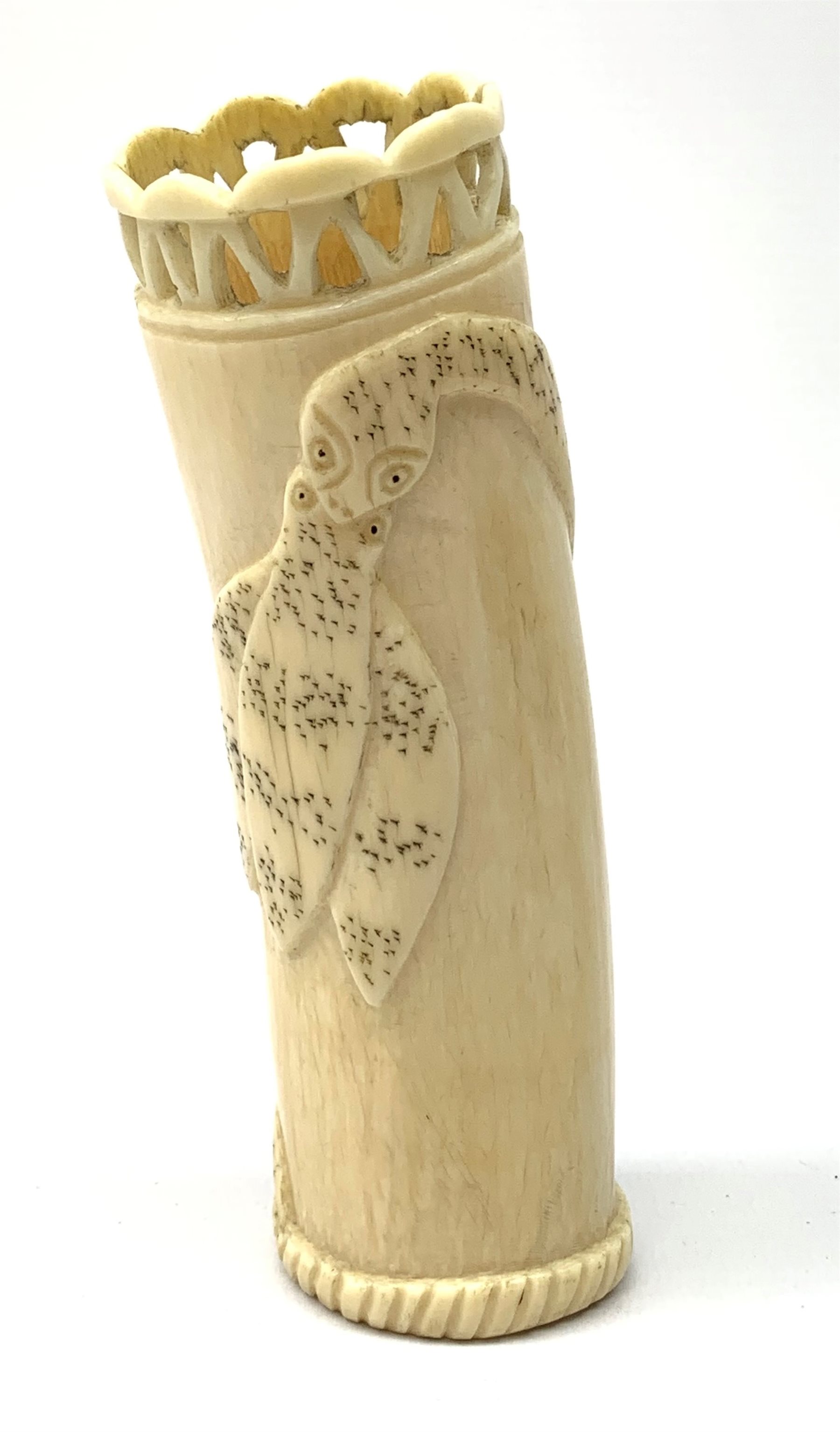 An African carved ivory spill vase, of cylindrical form with pierced rim and gadrooned band to base, the body decorated with snake and insect, signed to interior, H14cm.