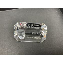 Swarovski Crystal Masquerade trilogy; 1999 Masquerade Pierrot, 2000 Columbine, 2001 Harlequin all with accompanying plaque, stand and original box, together with a glass display case with mirrored back and sides 