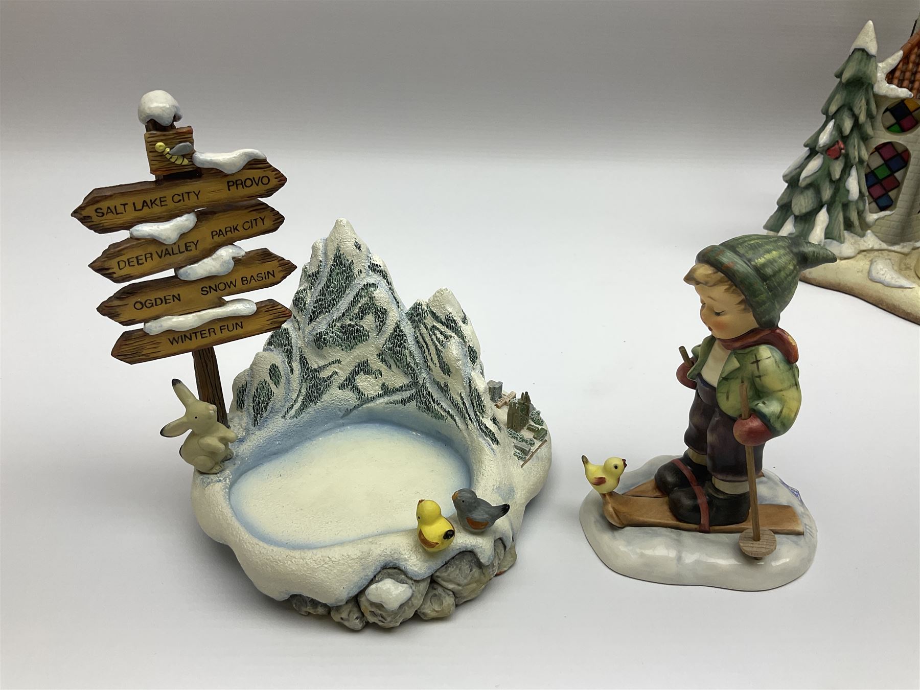 Eight Christmas Hummel figures by Goebel, to include Wintertime Chapel candle holder, Winter Fun, Christmas Morning, Christmas Time and Gingerbread Lane, tallest H21cm