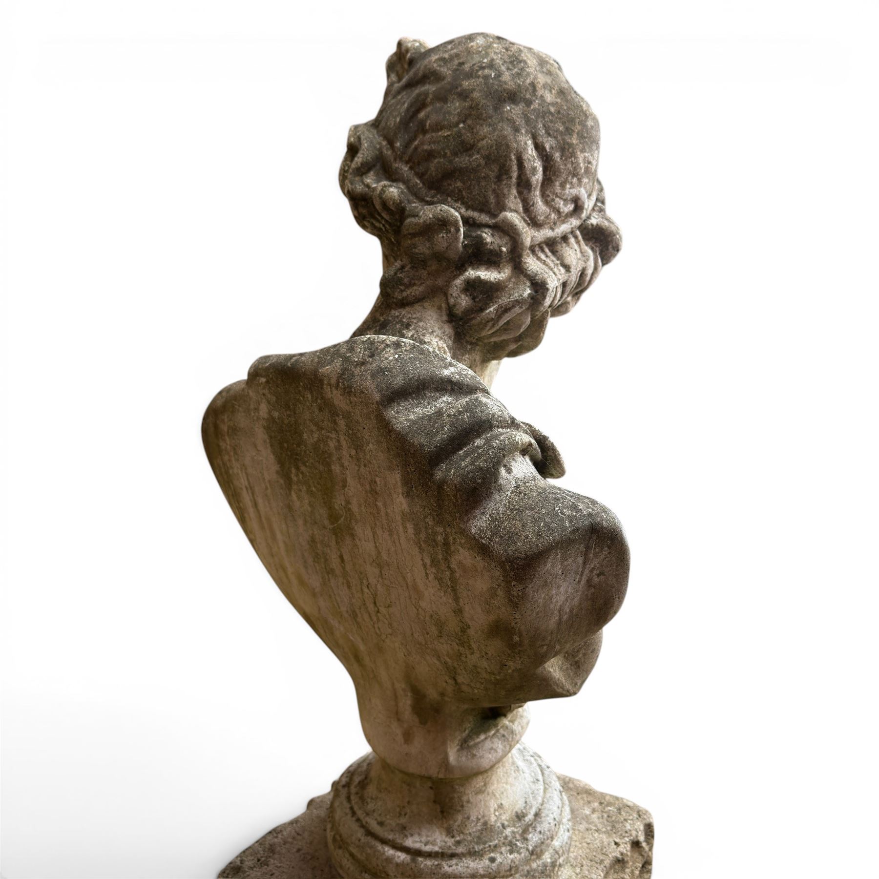 Roman Neoclassical style cast stone bust, weathered finish, raised on textured stone plinth of tapering form