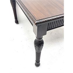 Early 20th century Hepplewhite style mahogany dining table, the rectangular top with foliate carved edge, fluted frieze rails carved with flower heads, turned and reeded acanthus supports with recessed castors