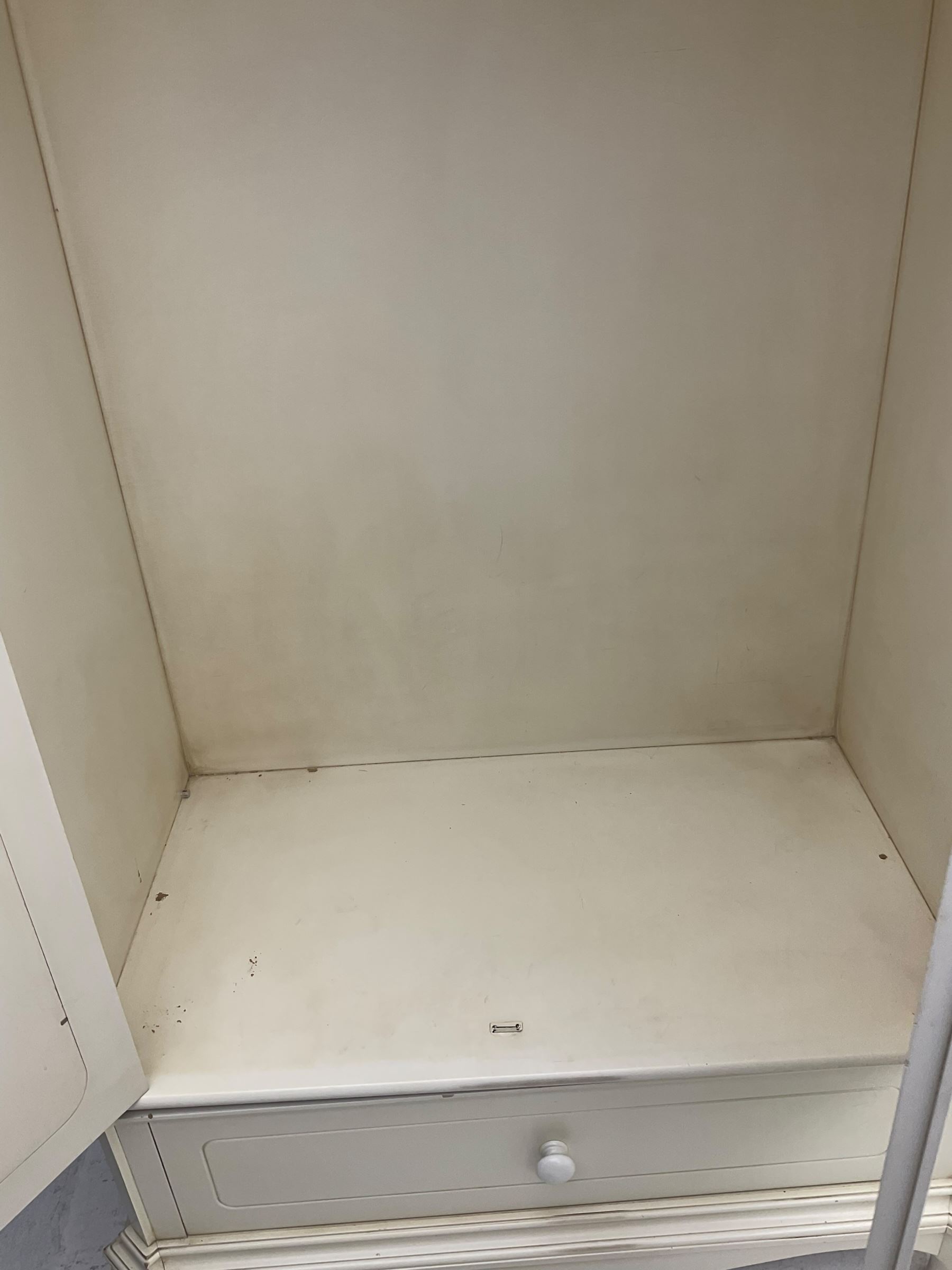 French design cream painted armoire wardrobe, shaped top with shell and flower head pediment, enclosed by two mirror glazed doors, the base fitted with single drawer