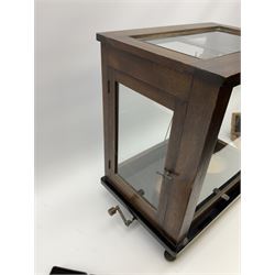 Set of laboratory balance scales by Paul Bunge Hamburg Model 9A No.7977 bearing label for Reynolds & Branson Leeds in mahogany case with upward sliding front door, two hinged side doors, hand cranked rise-and-fall facility and black vitrolite base L36cm H42cm D26cm; and two boxed part sets of weights (3)