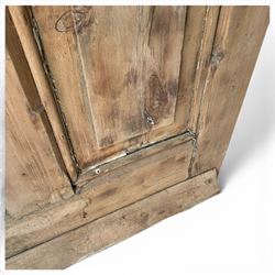 Victorian stripped pine four-panel door, the raised fielded panels within carved foliate and moulded surrounds, with iron lock and fittings and brass knob handle