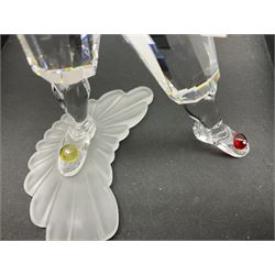 Swarovski Crystal Masquerade trilogy; 1999 Masquerade Pierrot, 2000 Columbine, 2001 Harlequin all with accompanying plaque, stand and original box, together with a glass display case with mirrored back and sides 