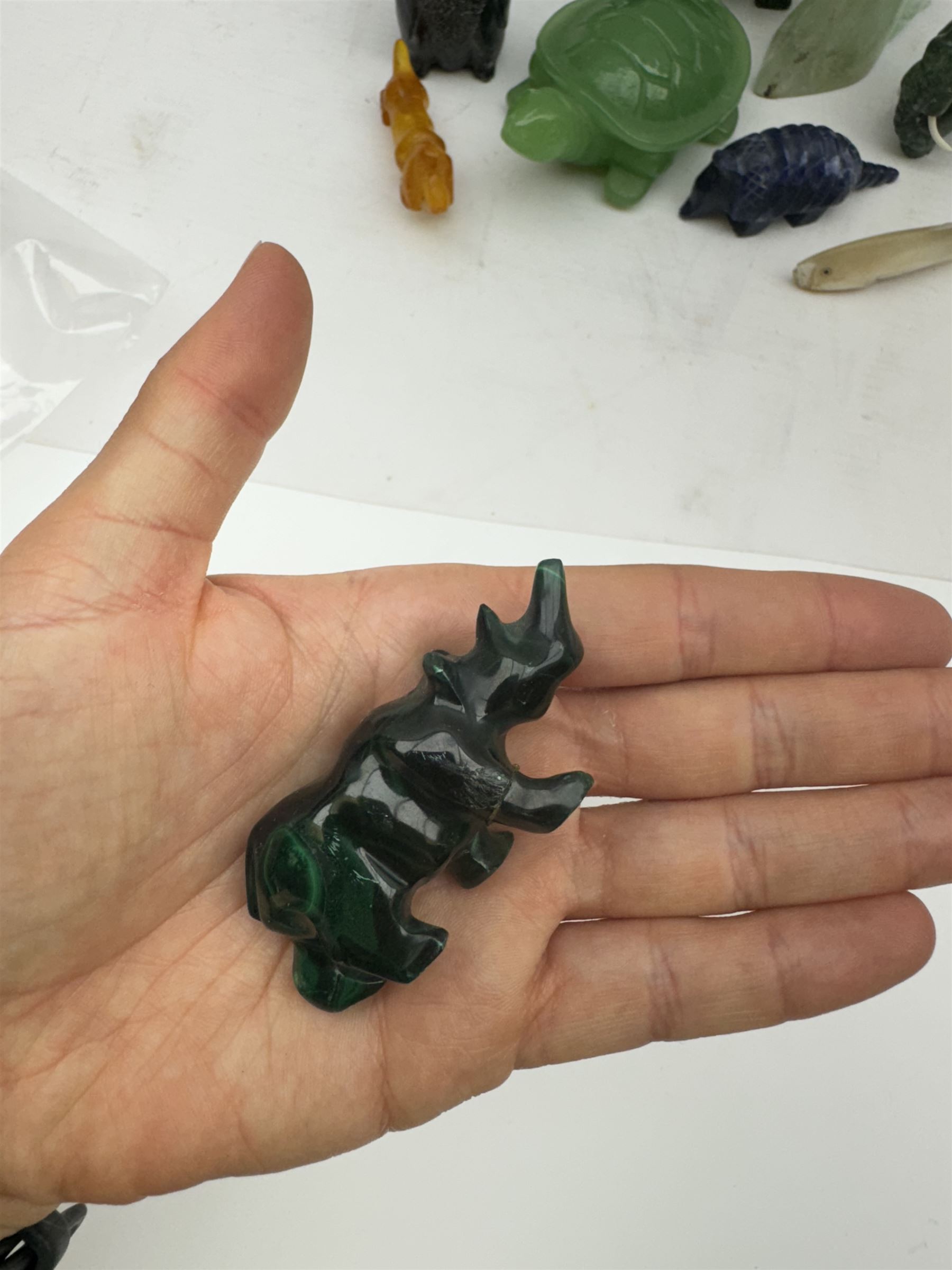 Collection of carved stone animals including  Lapis Lazuli armadillo, Malecite rhino, Amber dog etc  