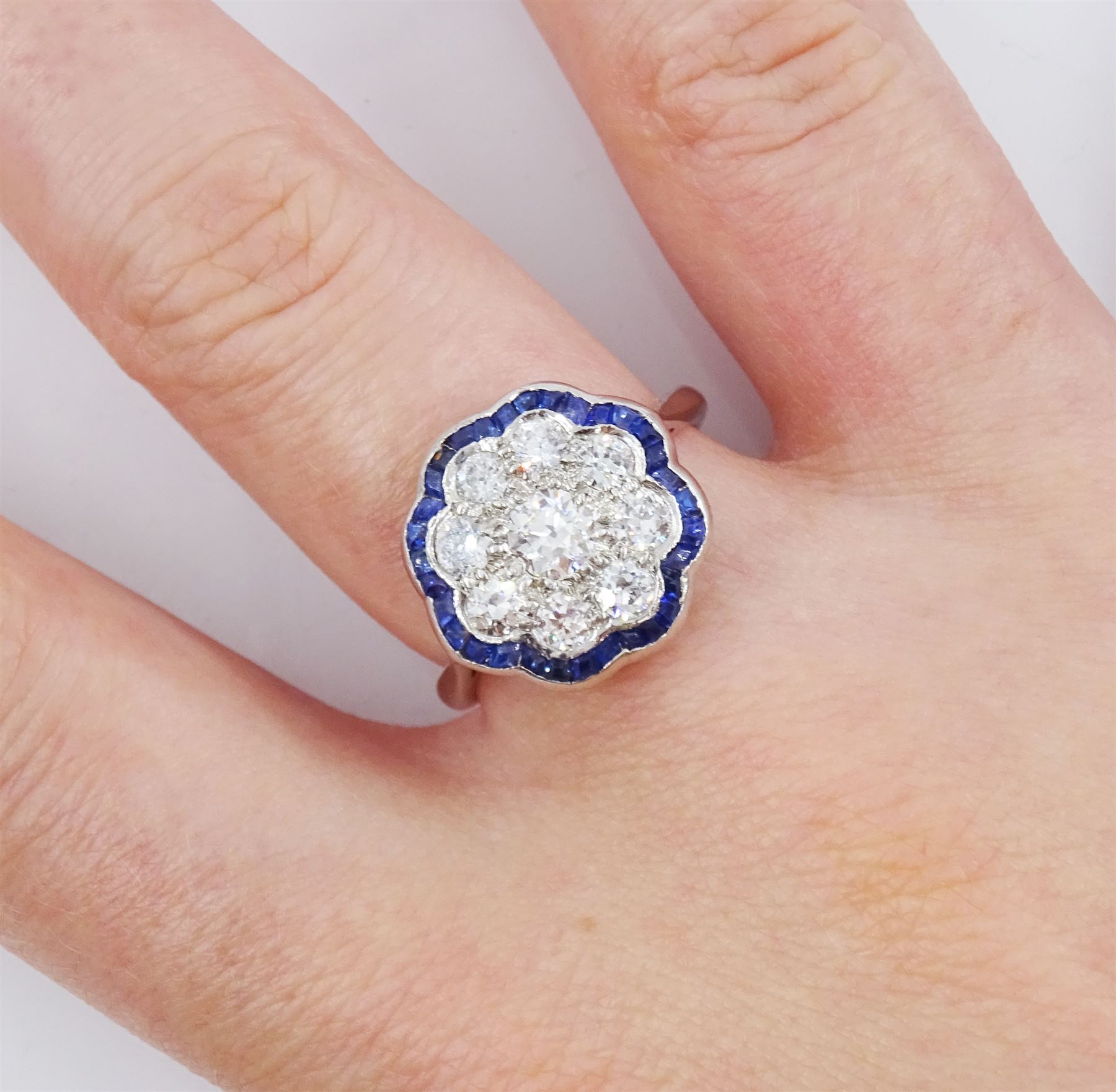 18ct white gold old cut diamond and calibre cut sapphire flower head cluster ring, total diamond weight approx 1.00 carat