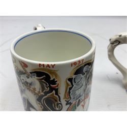Two Dame Laura Knight coronation mugs for King George VI and Queen Elizabeth, comprising a Burleigh Ware example and a J&G Meakin example, each with a lion moulded handle and printed marks beneath, H8cm