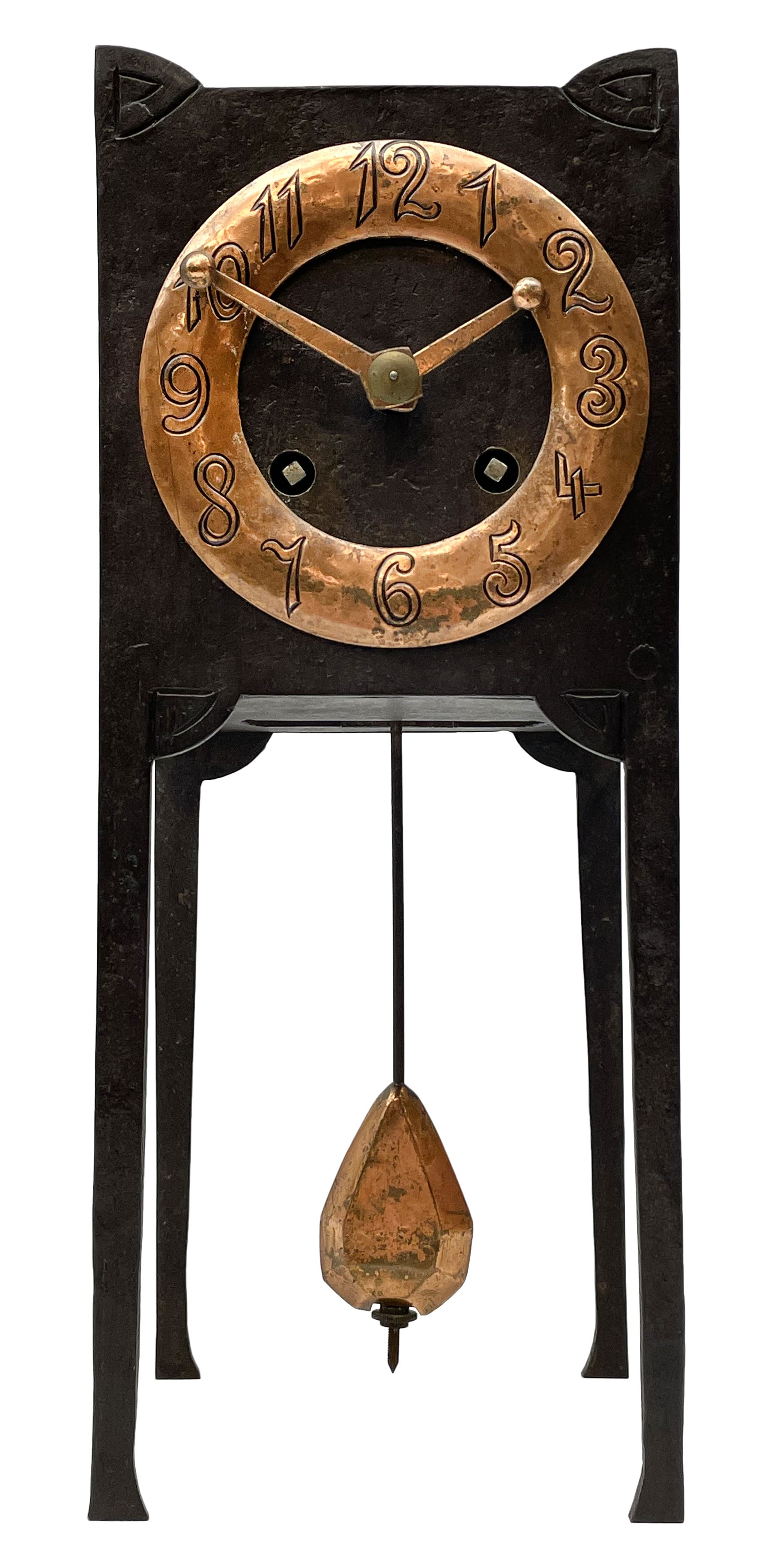A German Arts and Crafts 'Gesamtkunstwerk' mantle clock c1890 in a square formed iron case with abalone incised triangles to each corner, case raised on four legs with inward facing feet,  convex copper chapter ring hand engraved with upright Arabic numerals, conforming copper hands in an individual style, with an eight-day spring driven rack striking movement manufactured by Lenzkirch, striking the hours and half hours on a bell, conforming steel pendulum with a hand-crafted faceted pear-shaped copper bob. With key.
Lenzkirch were one of the most prolific and respected German clock manufacturers of the 19th and early 20th century, it is highly probable that this movement was removed from another clock and incorporated into this artisan case when made at the end of the 19th century.