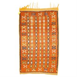 North Persian tribal rug, an orange field and six rows of lozenges, with a border of ram's...
