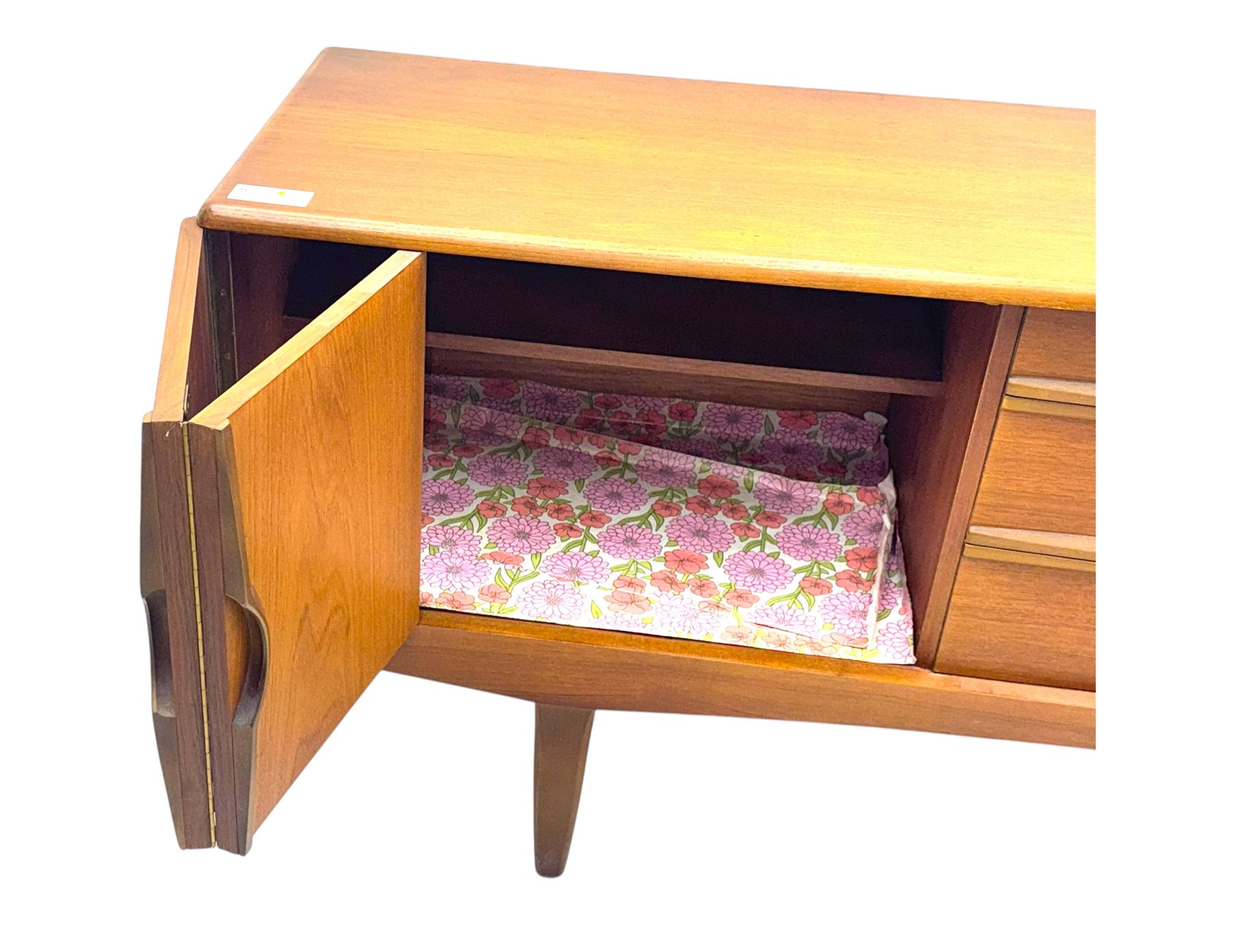 Stonehill - mid-20th century teak sideboard, three central drawers flanked by concertina cupboard doors, on tapering supports