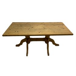 Rectangular waxed pine dining table, on turned pedestals joined by stretched with splayed supports