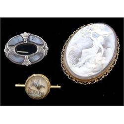 Early 20th century rose gold cameo brooch depicting a goddess by the sea possibly Amphitrite, stamped 9ct makers mark H & N (possibly Hollis & Newman), the back inscribed 'Ted to .. and dated 1912', early 20th century gold Essex crystal jump jockey brooch and Victorian silver blue agate brooch