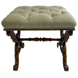 Victorian walnut dressing stool, square seat upholstered in buttoned laurel green fabric, raised on twin shaped X-frame end supports with carved S-scroll decoration, united by a turned stretcher 