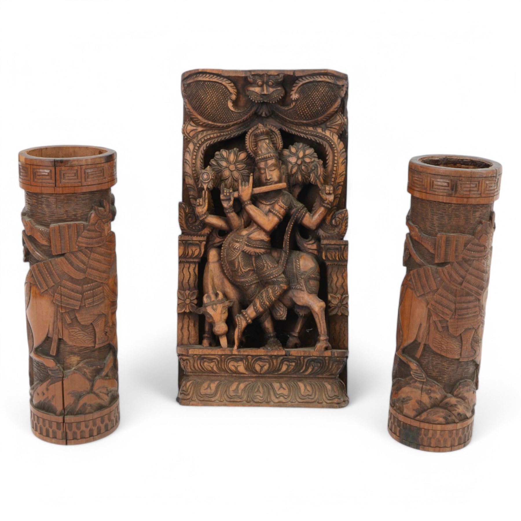 Pair of Japanese carved bamboo brush pots, each depicting a Samurai on horseback, together with an Indian wooden carved panel depicting the Hindu God Krishna, tallest H46cm