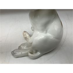 Royal Copenhagen figure of a pointer puppy, modelled seated with rare white and brown patch colourway, designed by Erik Nielsen, model no 259, date code for 1889-1922, with printed and painted marks beneath, H19cm