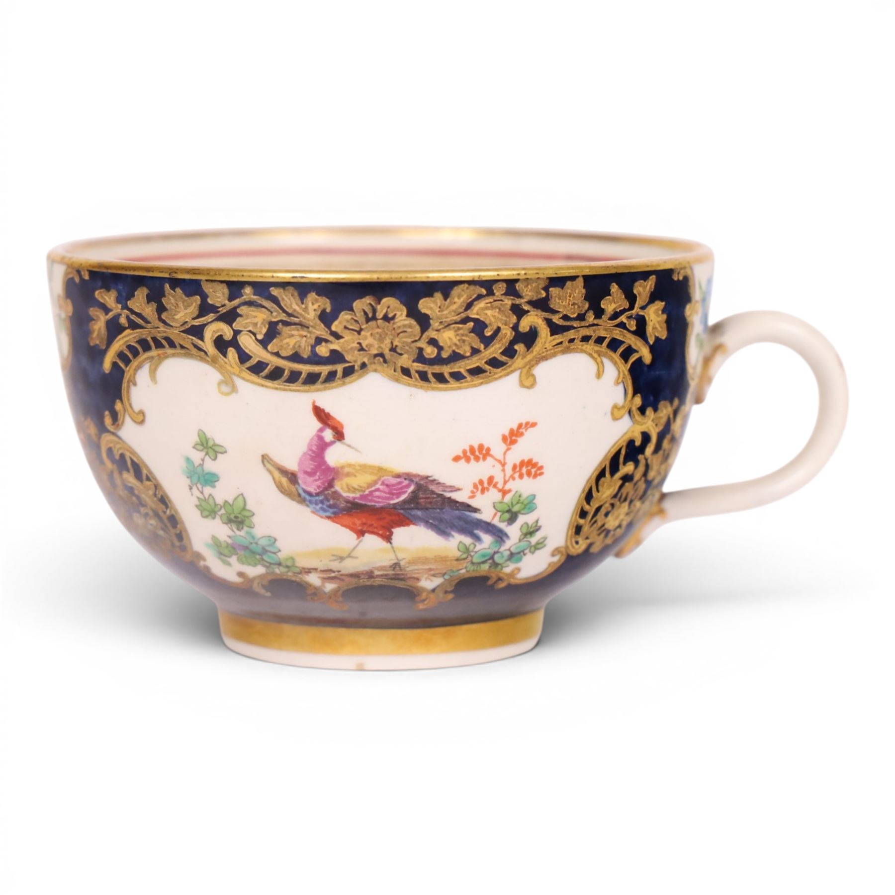 18th century Worcester trio, circa 1770,  painted with shaped panels of birds within a gilt boarder upon a blue scale ground with gilt detail to the rim, mark beneath, H7cm 
