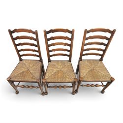 19th century set of six ash and elm ladderback dining chairs, shaped ladder backs above rush seats, raised on turned front supports with pad feet, united by turned stretchers