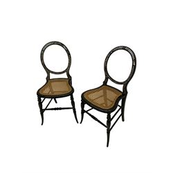 Pair Victorian balloon back bedroom chairs, black lacquered and decorated with mother of pearl in Greek key design, cane seats, on turned supports