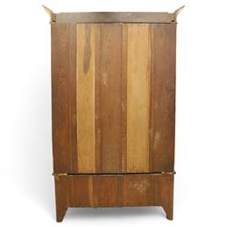 Art Nouveau oak wardrobe, central mirrored door flanked by panels inlaid with stylised tulip motifs, fitted with hanging rail and hooks, single drawer to base with brass handles