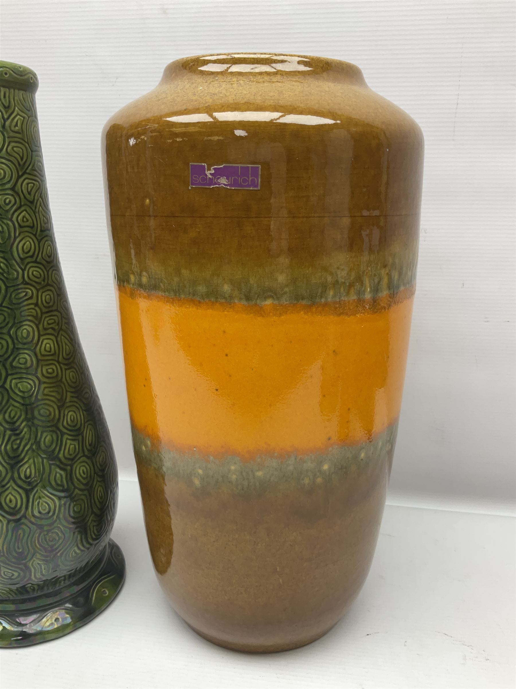 Burmantofts Faience vase, with elongated neck, and concentric circle decoration, in a green lustre glaze, together with a Bretby figure, modelled as a cat with a ball of wool, a Bretby vase, with fluted rim, in orange/red glaze, frog jug and a large West German vase, tallest H38cm